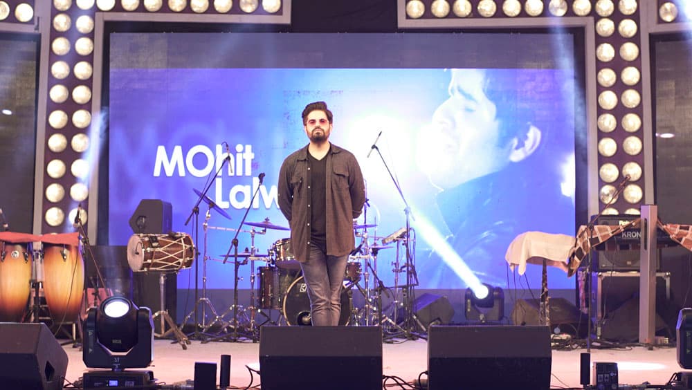 Close-up of MOhit singing into a microphone